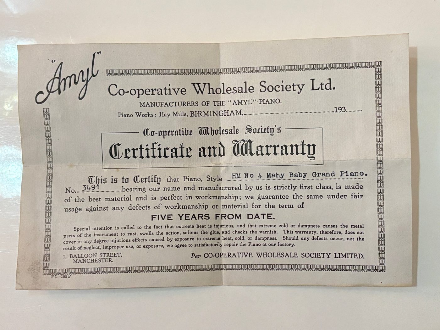 Co-operative Wholesale Society Certificate and Warranty for an Amyl HM No 4 mahogany baby grand piano, number 3491, guaranteed for five years from date