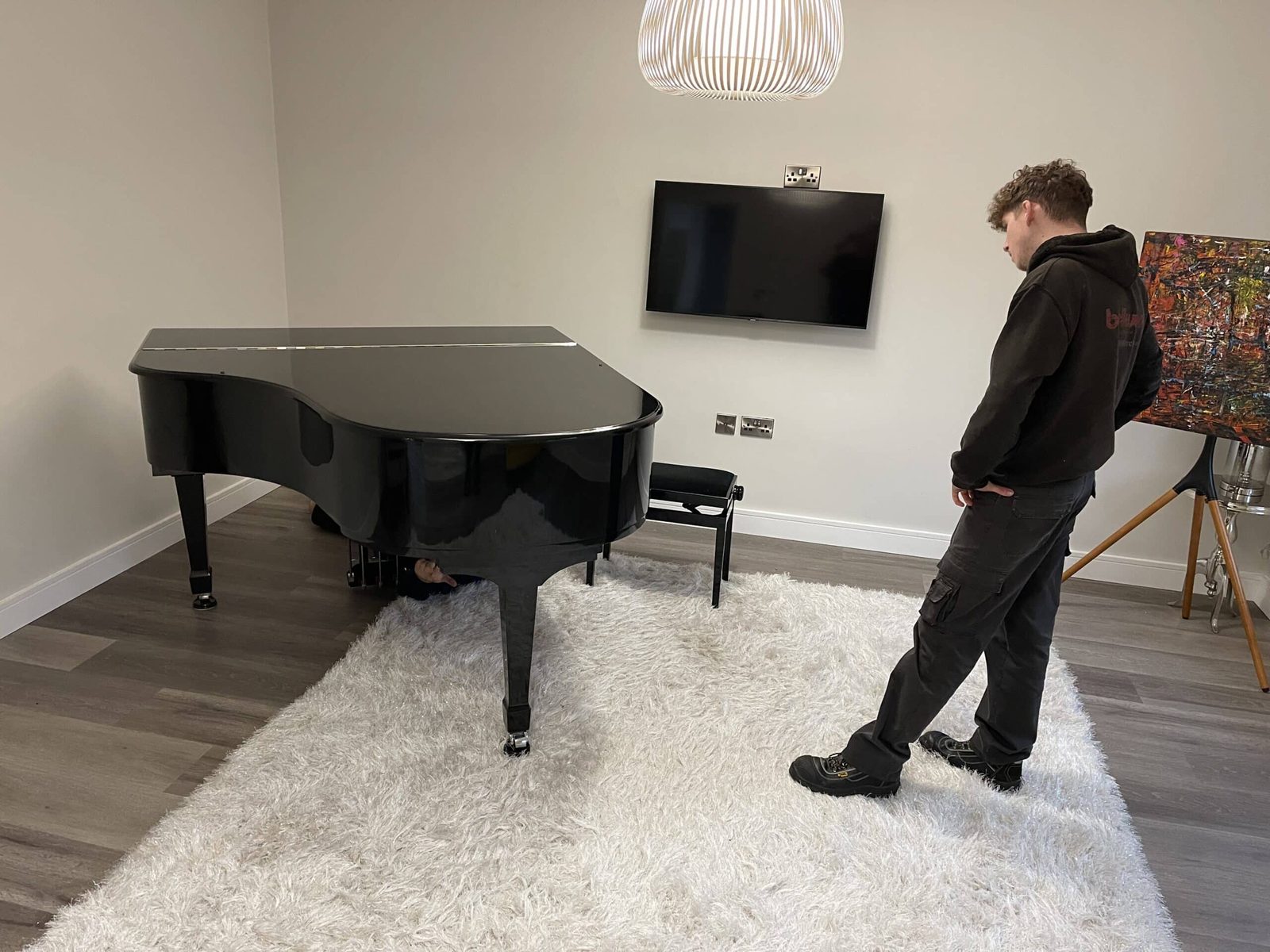 Grand piano being positioned in a modern Yorkshire home