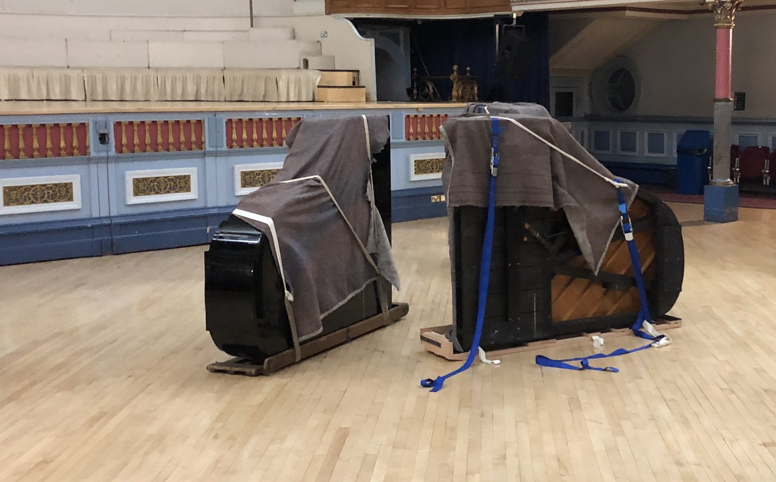 Grand pianos on skid boards at Huddersfield Town Hall