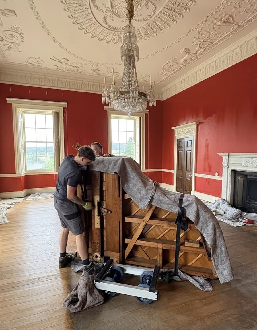 Upright piano braced on a trolley in a period state room near Harrogate