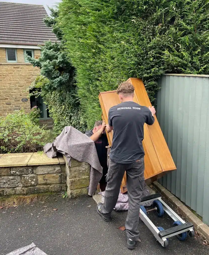 Upright piano being moved by the Yorkshire Piano Logistics team