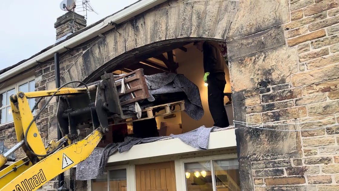 Yamaha grand piano being lifted to a first-floor window in Wakefield